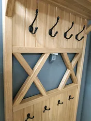 Clothes hangers in the hallway made of wood photo