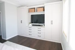 TV built into the closet in the bedroom photo