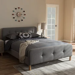 Gray bed with a soft headboard in the bedroom interior photo