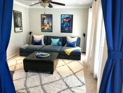 Living room with blue sofa and blue curtains photo