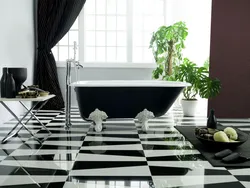Bathtub Made Of White And Black Tiles In The Bathroom Photo