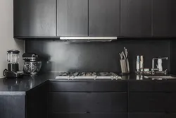 Gray kitchen with dark countertops in the interior photo