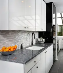 Gray kitchen with dark countertops in the interior photo