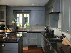 Gray kitchen with black countertop and apron in the interior