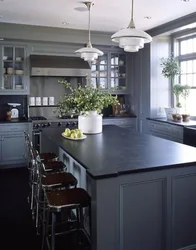 Gray kitchen with black countertop and apron in the interior