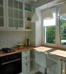 Kitchen design in Khrushchev with a window sill and countertop