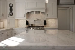 White kitchen with marble countertop and apron in the interior