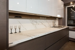 White Kitchen With Marble Countertop And Apron In The Interior