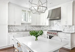 White kitchen with marble countertop and apron in the interior