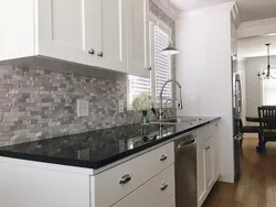 White kitchen with marble countertop and apron in the interior