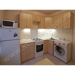 Kitchens with a washing machine under the countertop corner photo