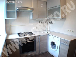 Kitchens with a washing machine under the countertop corner photo