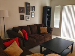 Living room with dark sofa design photo