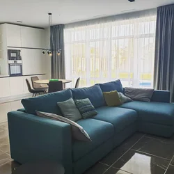 Living room design with gray sofa and curtains
