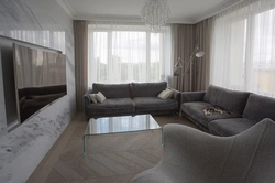 Living room design with gray sofa and curtains
