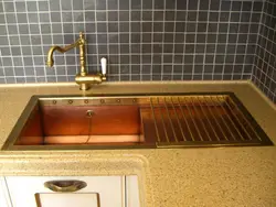 Golden sink in the kitchen interior