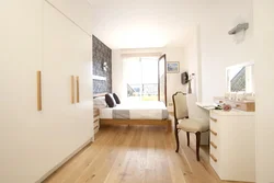 Interior of a narrow bedroom with one window