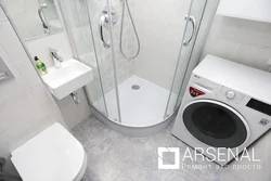 Photo of a bathroom with shower and washing machine photo