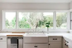 Kitchen design by the window with a sink in the apartment