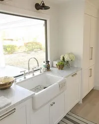 Kitchen design by the window with a sink in the apartment