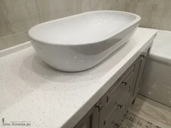 Sink in a stone countertop in a bathroom photo