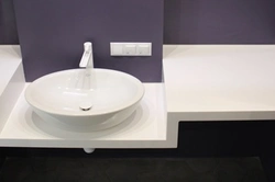 Sink in a stone countertop in a bathroom photo