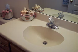 Sink in a stone countertop in a bathroom photo