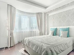 Curtains in the bedroom in the interior white wallpaper