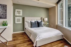 Bed against the wall photo design in a small bedroom