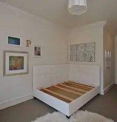 Bed against the wall photo design in a small bedroom