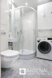 Bathroom with shower cabin design in apartment and washing machine