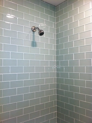 Photo of a bathtub with grout matching the color of the tiles