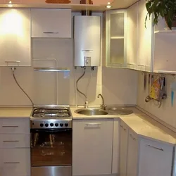 Photo of a small kitchen with a window and a column