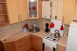 Photo Of A Small Kitchen With A Window And A Column