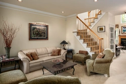Design of a living room in a house with a photo staircase to the second floor