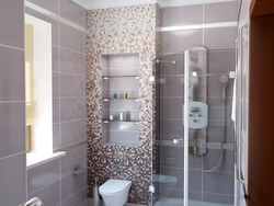 Shower in the bathroom with a tray made of small tiles photo
