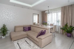 Living room interior in an apartment in light colors and corner sofas