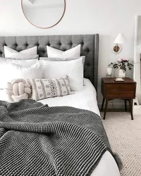 Bedroom design with a gray bed with a soft headboard