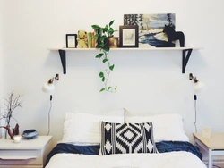 Shelves above the bed in the bedroom interior