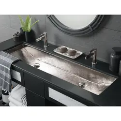 Washbasin on the countertop in the bath photo