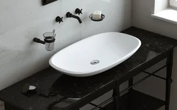Washbasin on the countertop in the bath photo