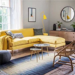 Photo of a living room with a mustard-colored sofa