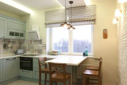Design of a small kitchen with a window in an apartment