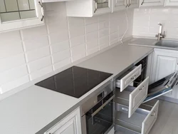 White kitchen design with gray countertop photo