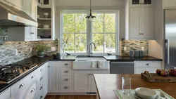 Kitchen design with a window in a classic style