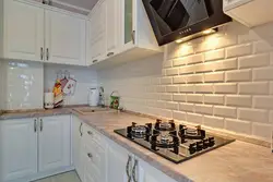 Bright corner kitchen with refrigerator photo