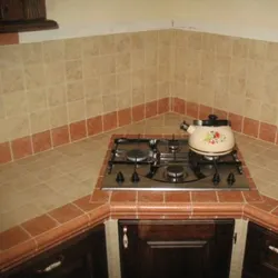 Bright corner kitchen with refrigerator photo