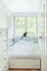 Double bed by the window in a small bedroom photo