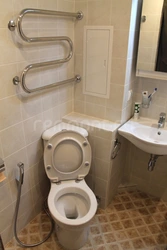Toilet in the bathroom in the corner photo