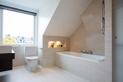 Bathroom design in the attic with a sloping ceiling